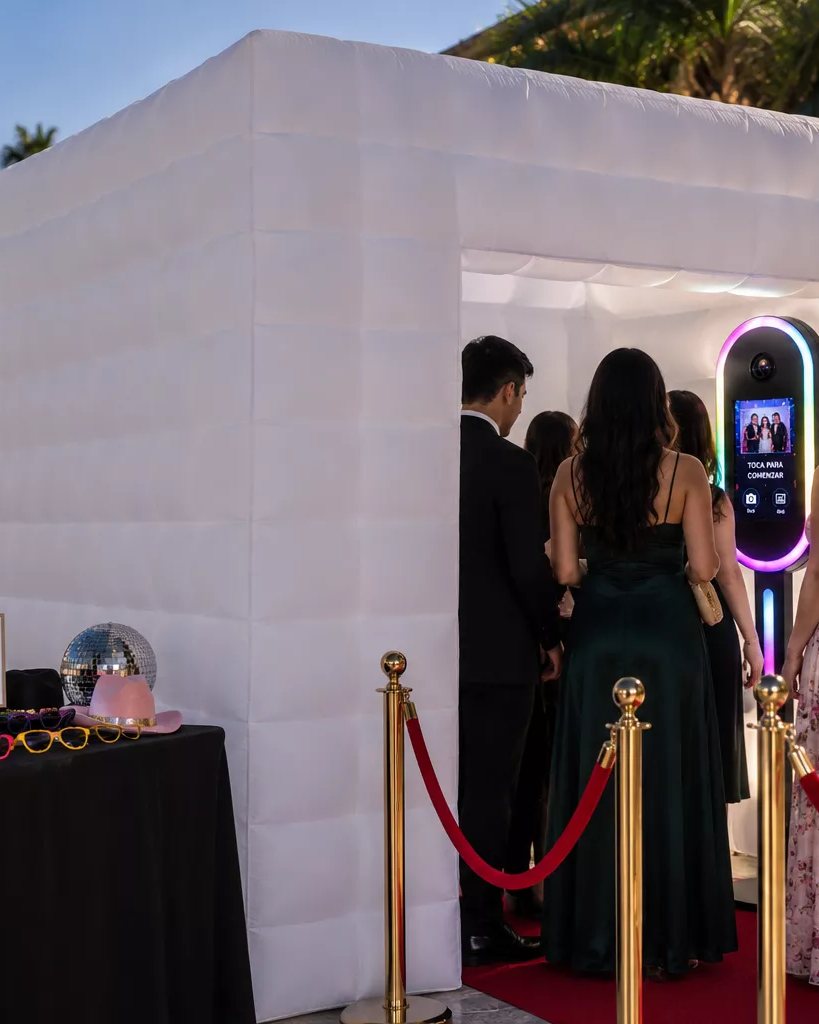 Guests stepping into the illuminated LED photo cabin along a red carpet