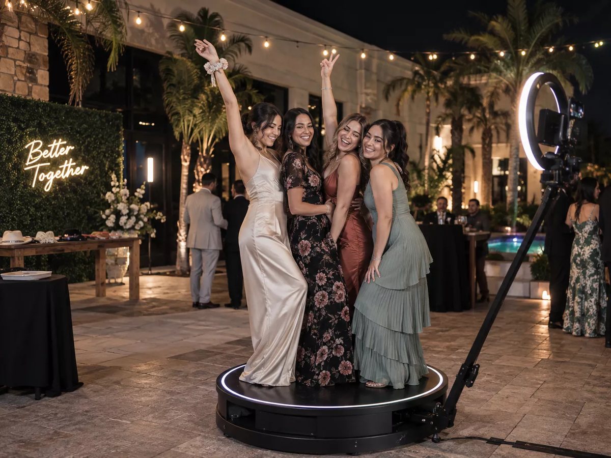 A newlywed couple on the 360° photo booth platform